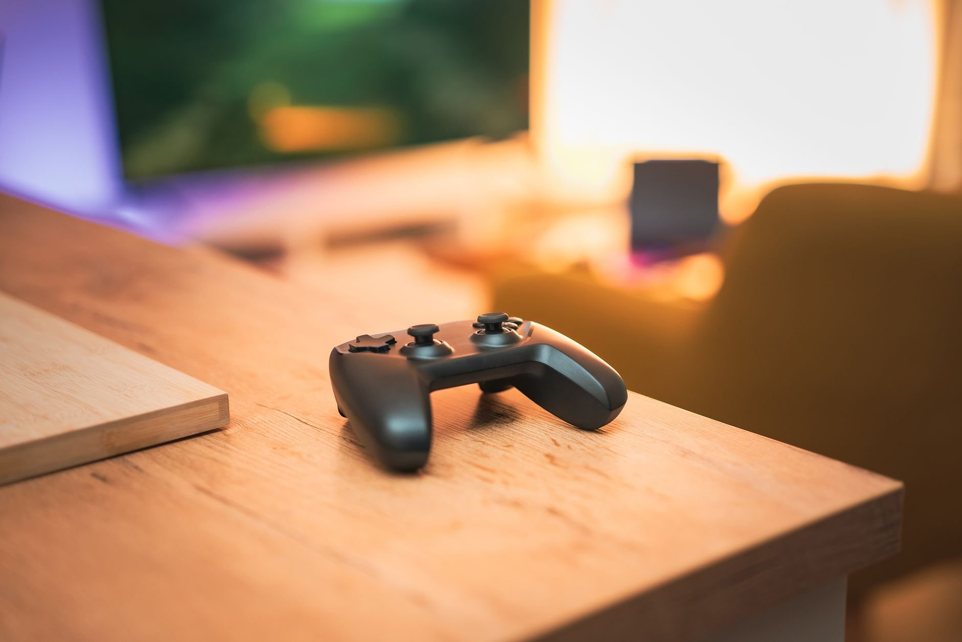 A cozy indoor scene with a video game controller on a desk, perfect for gaming enthusiasts.